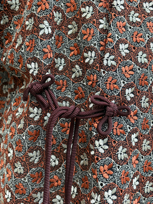 Maroon himo cords tying across the front of the haori