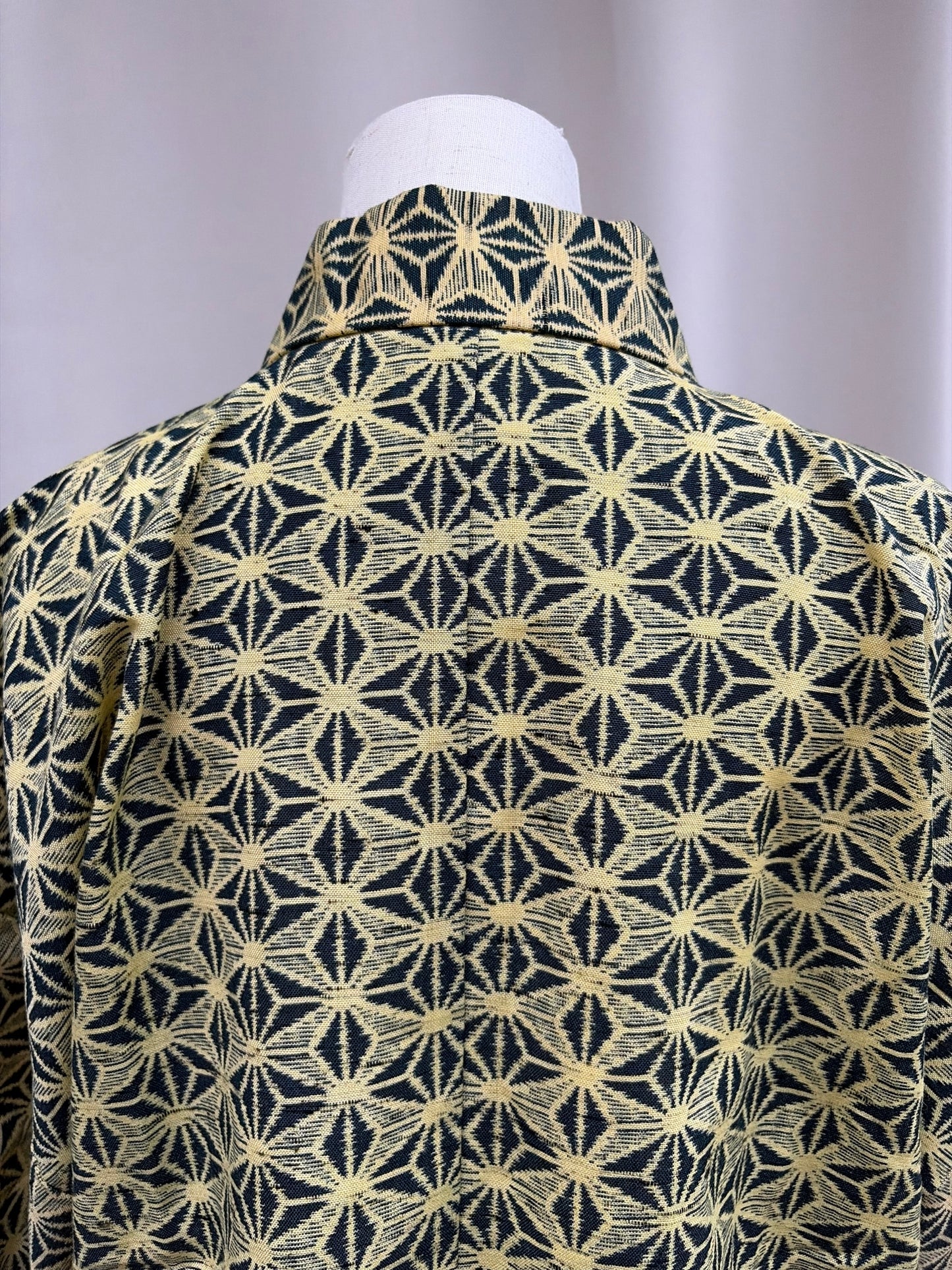 Close-up of the cream-gold asanoha hemp-leaf jacquard on navy