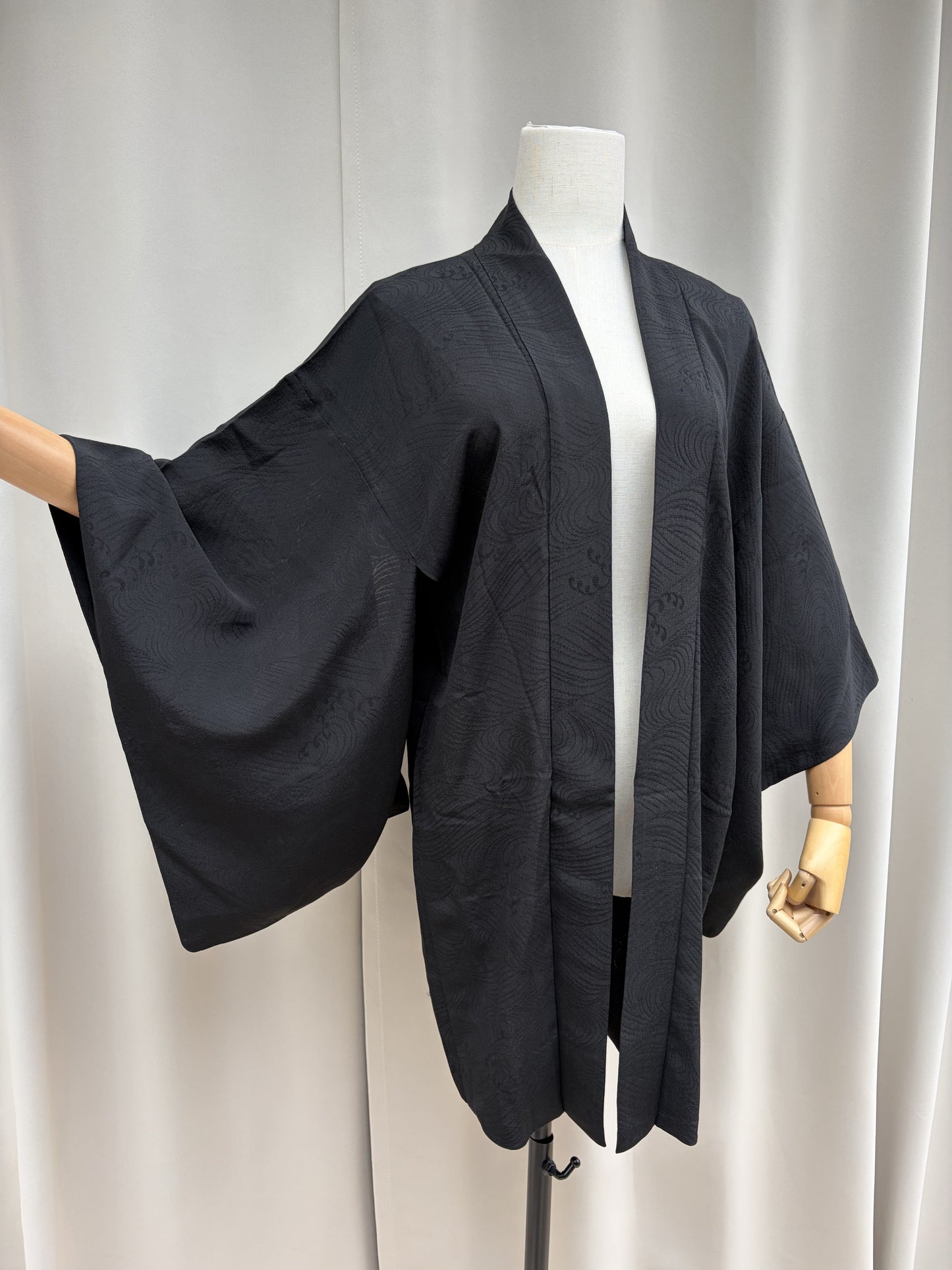 Black sheer summer haori with a woven wave pattern, front view on a mannequin