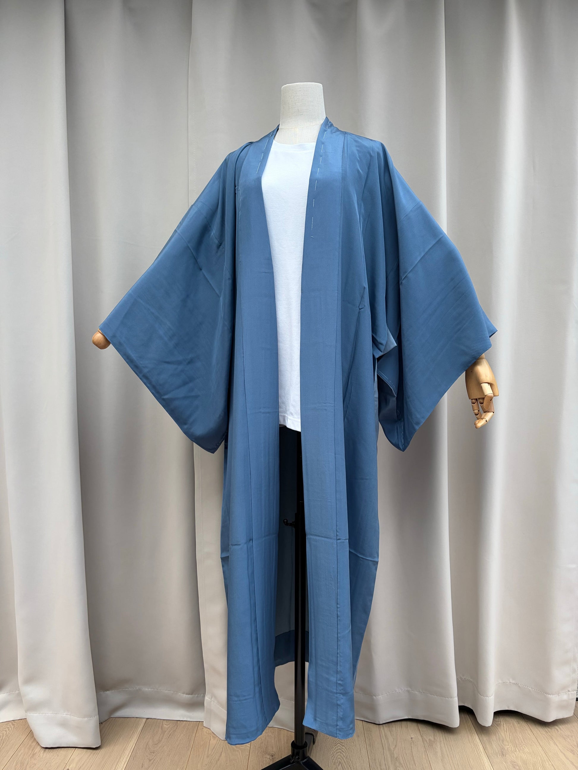 Blue men's nagajuban worn open like a robe over a white top on a mannequin