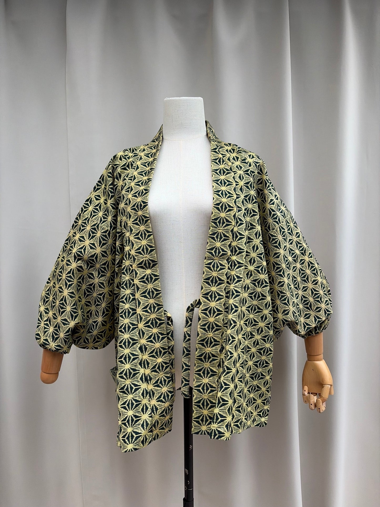 Cream-gold asanoha hemp-leaf hug-me haori, front view on a mannequin