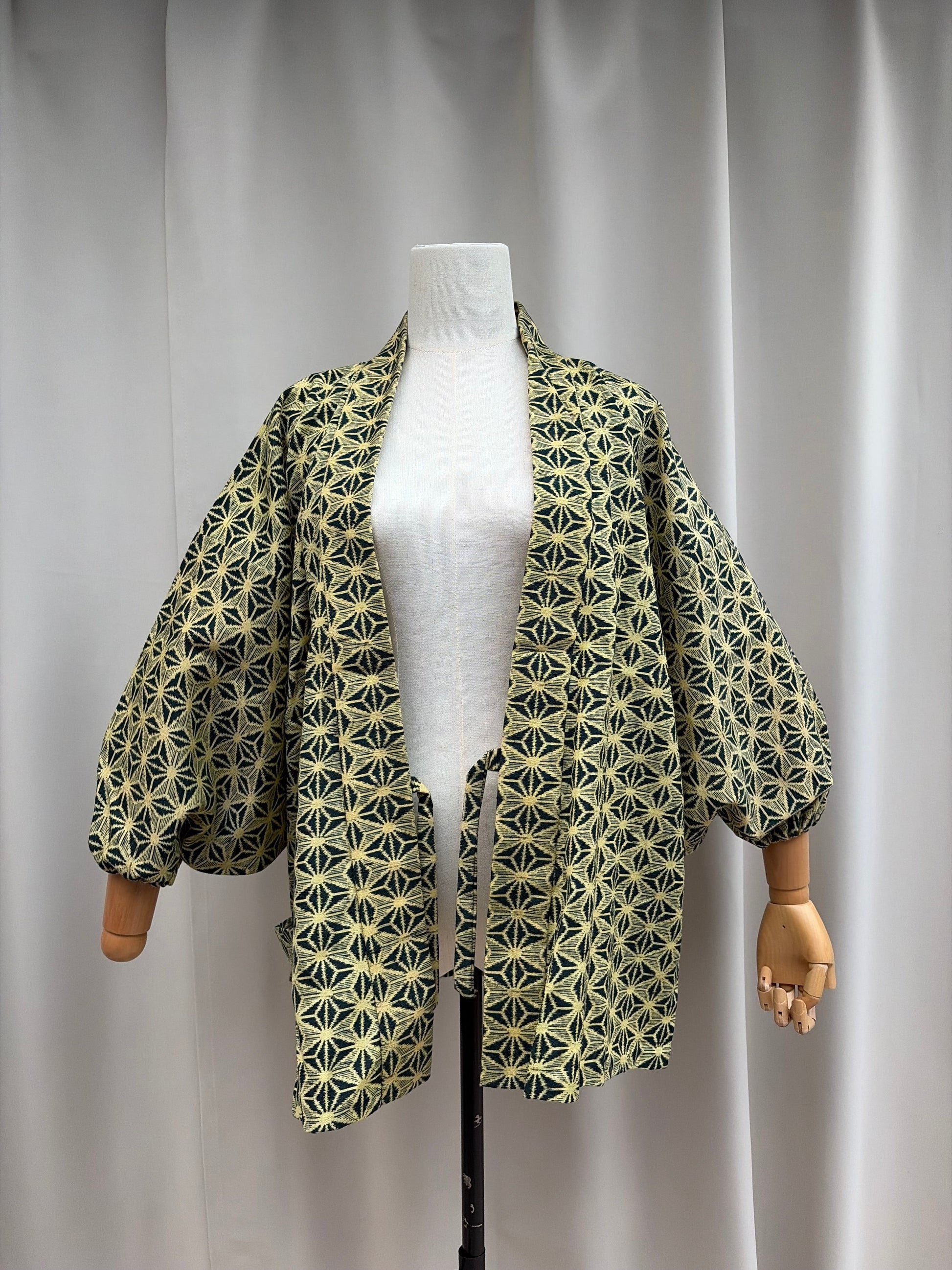 Cream-gold asanoha hemp-leaf hug-me haori, front view on a mannequin