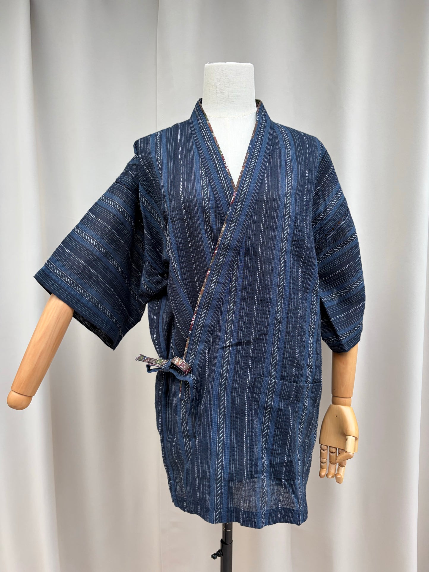 Navy Japanese men's jinbei top with woven stripes on a mannequin