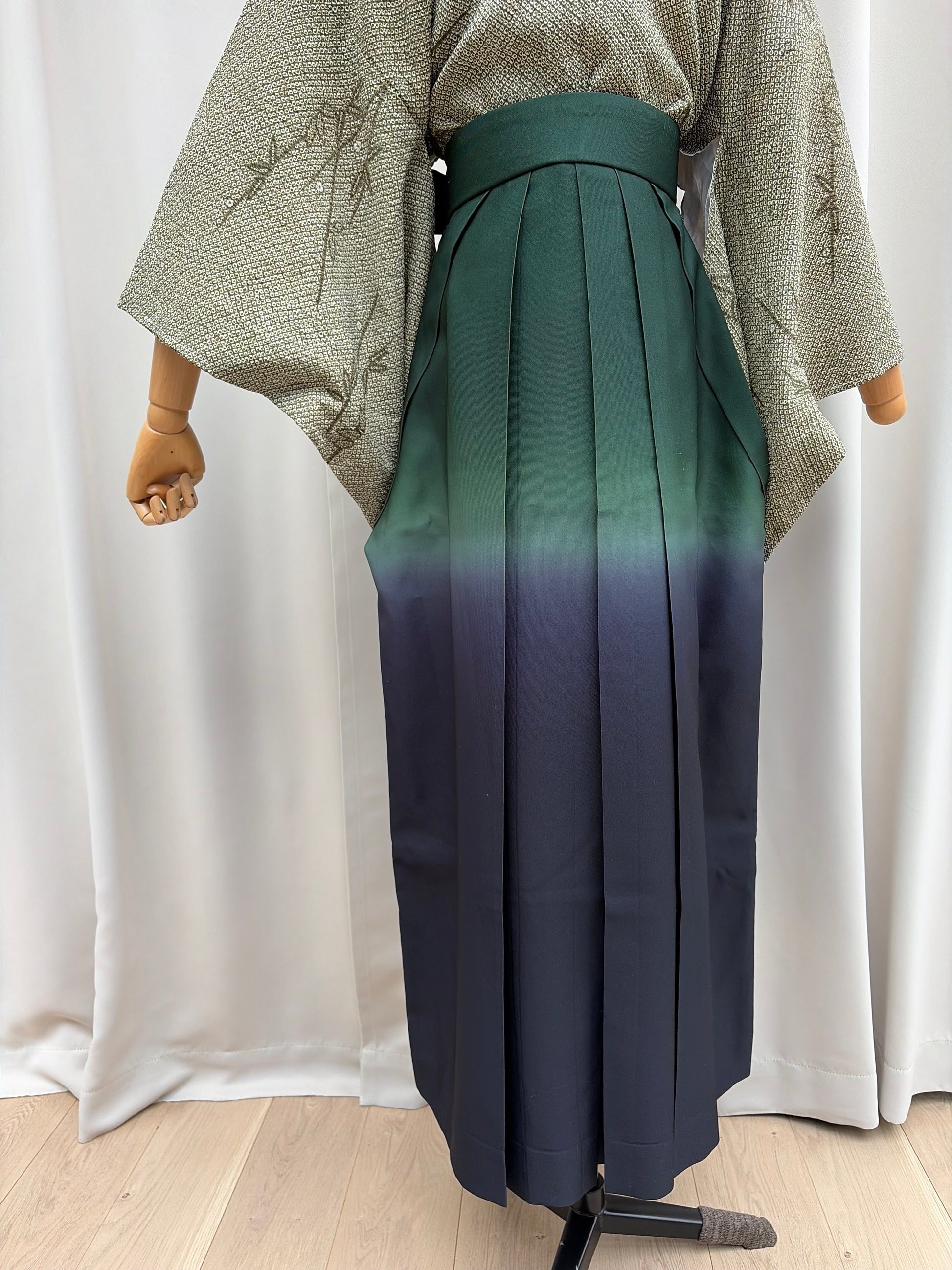 Front view of the navy-to-green ombre pleated hakama