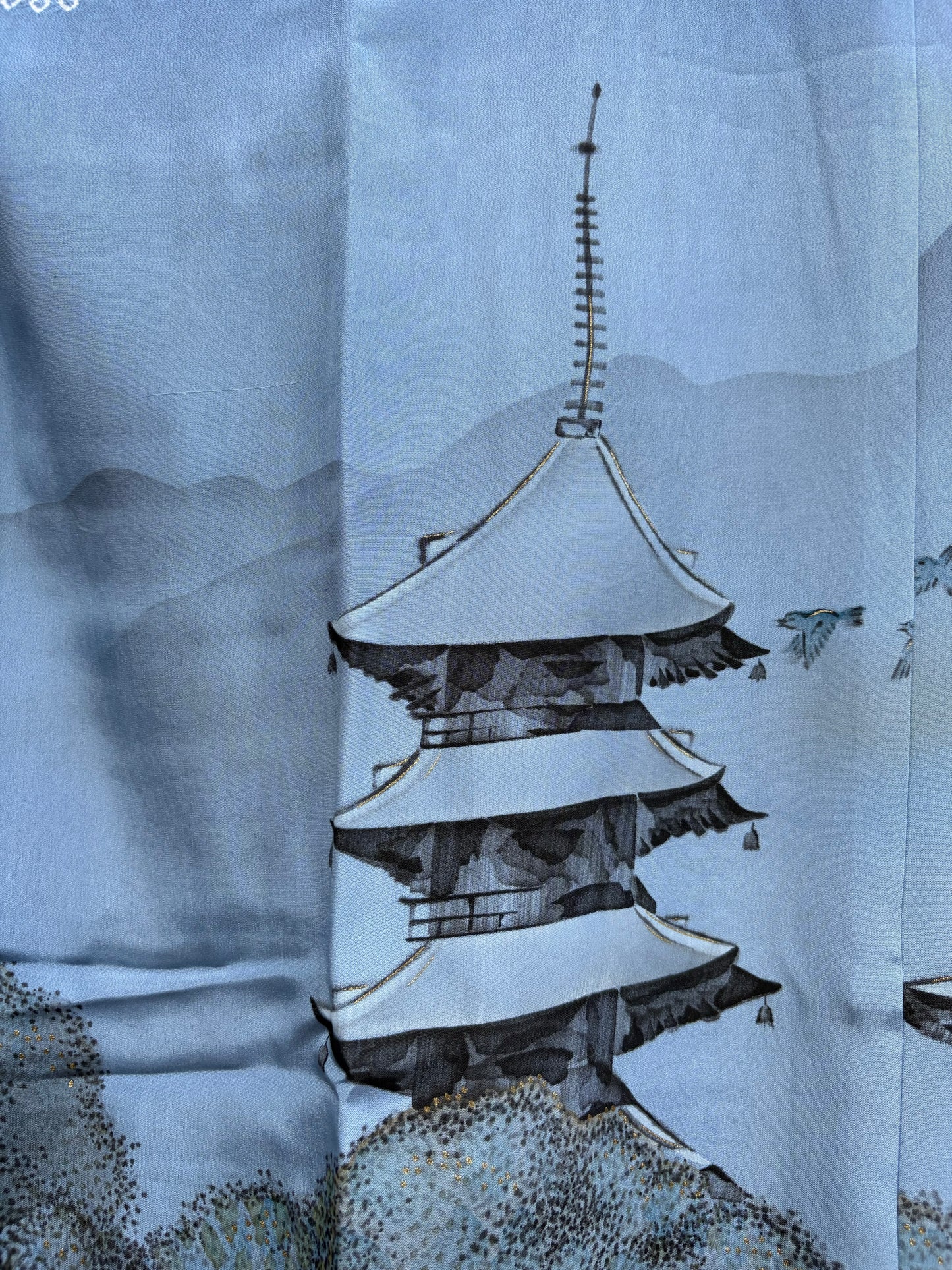 Close-up of the hand-painted five-storey pagoda with gold-line accents