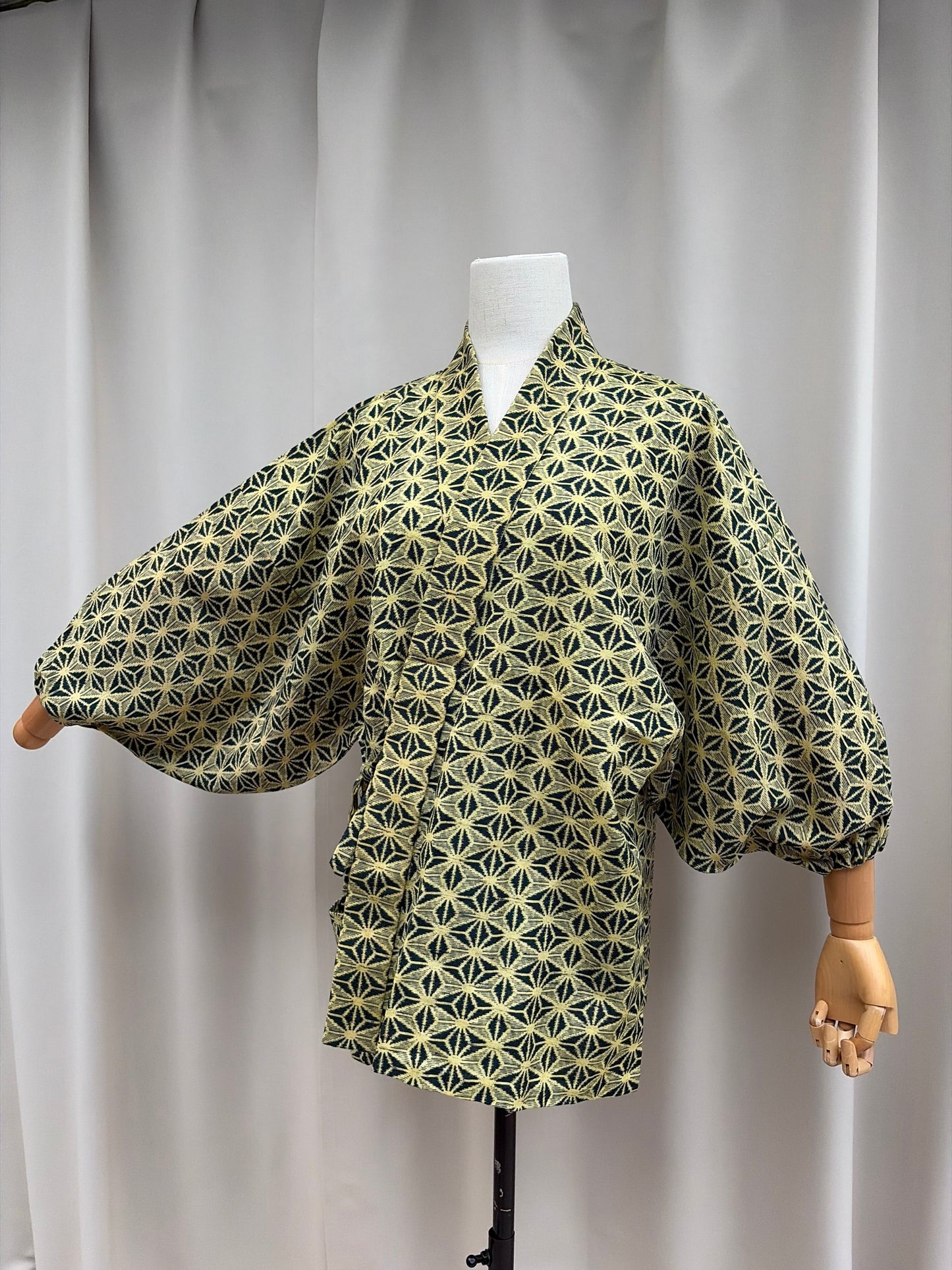 Three-quarter view of the cream-gold and navy asanoha summer haori