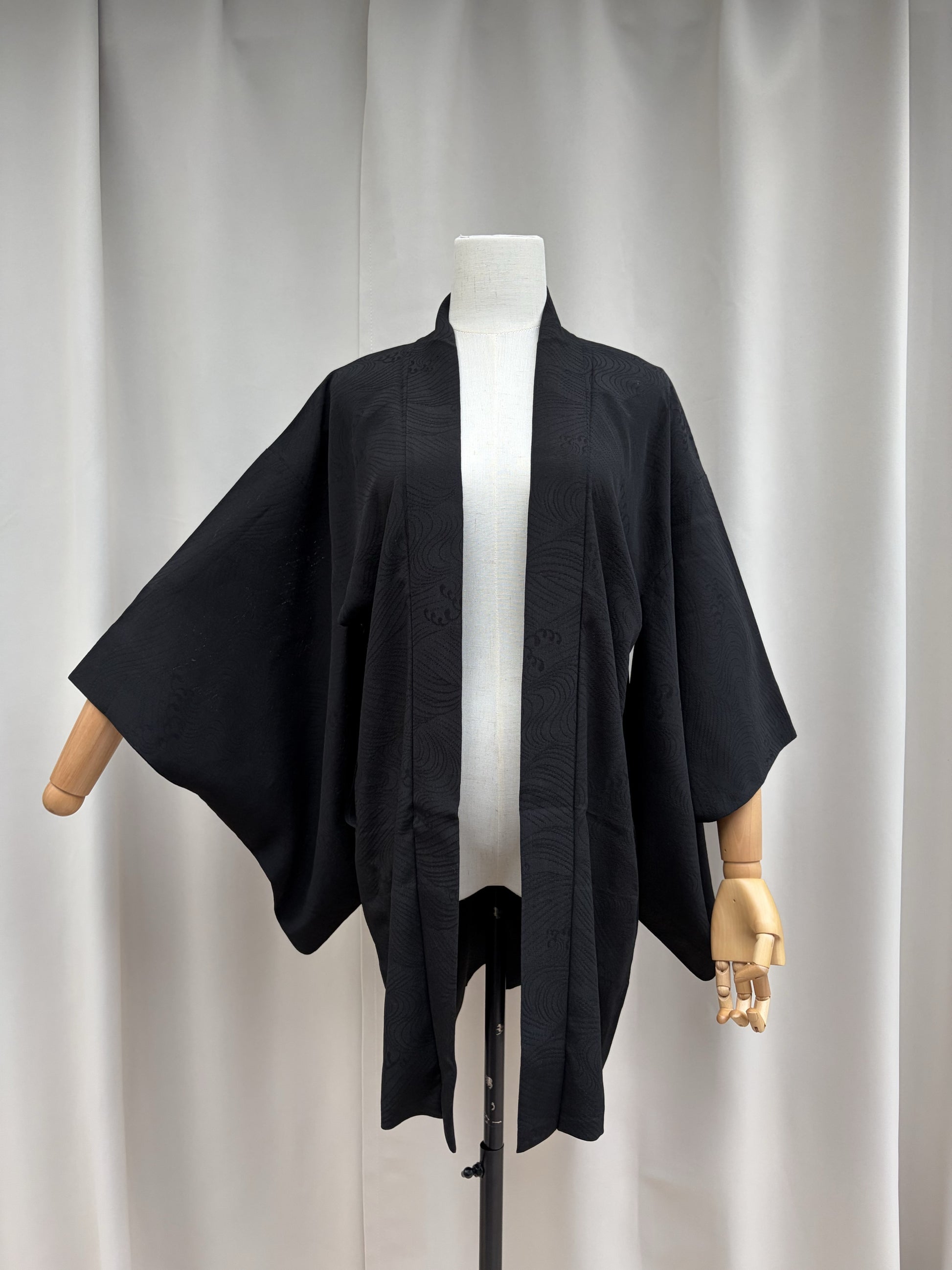 Front view of the black sheer summer haori on a mannequin