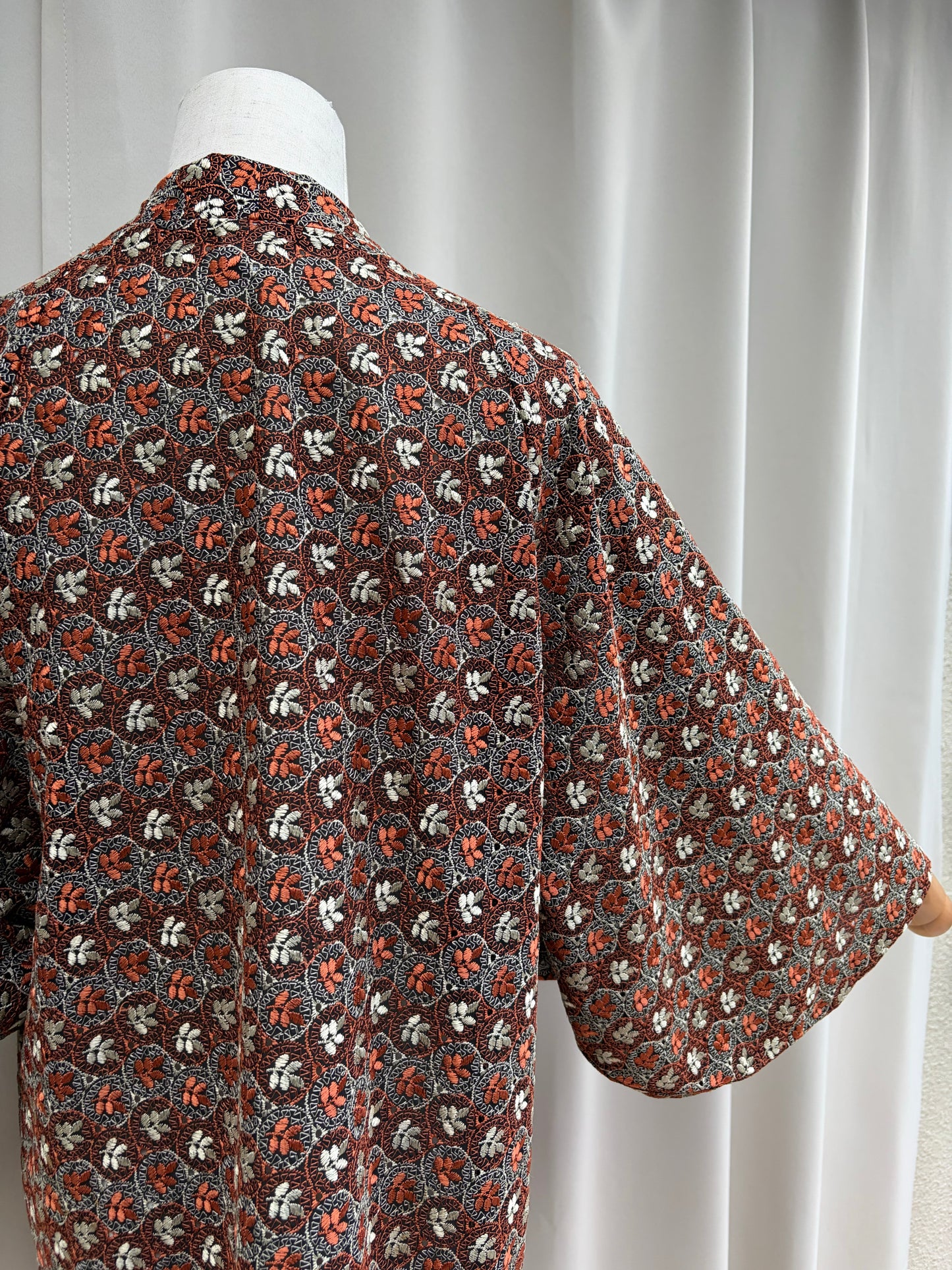 Draped detail of the rust, cream and grey floral pattern
