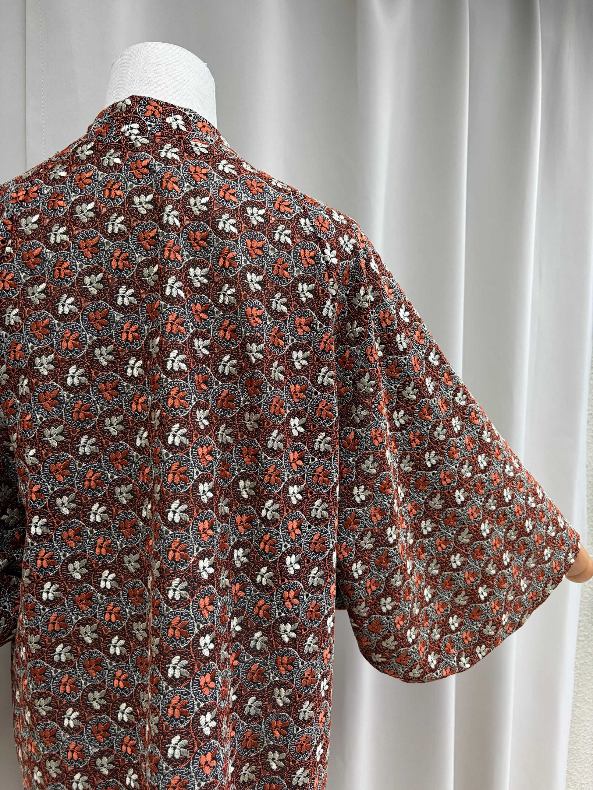 Draped detail of the rust, cream and grey floral pattern