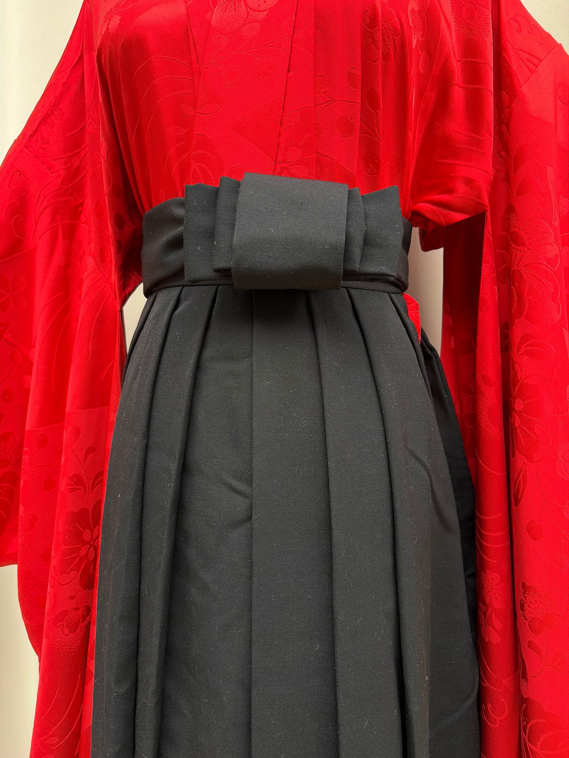 Long himo ties knotted at the waist of the hakama