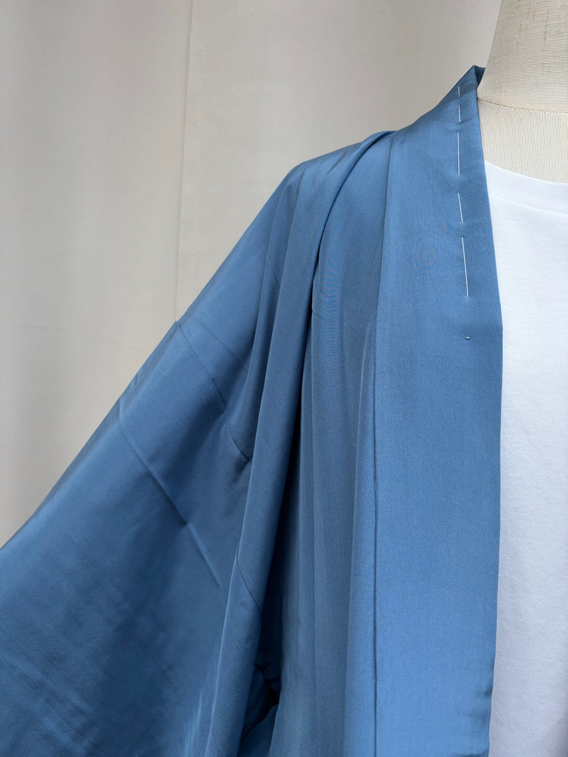 Original white shitsuke basting threads showing the garment is unworn