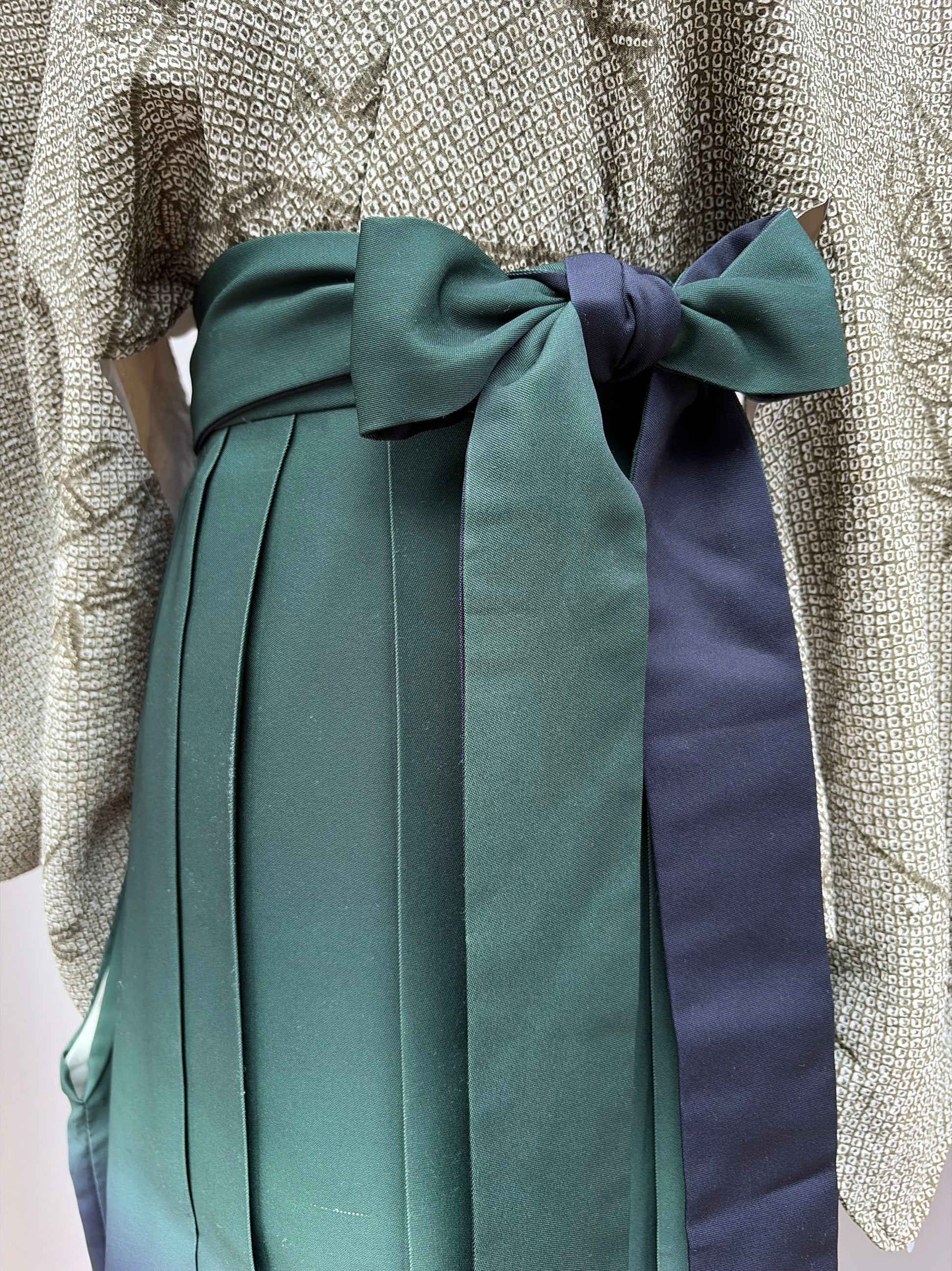 Long himo ties knotted at the waist of the hakama