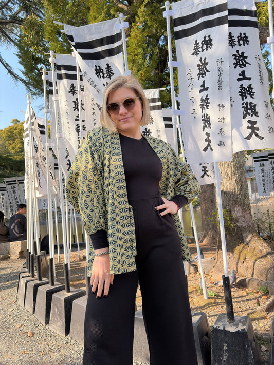 Woman wearing the asanoha hug-me haori over black at a Japanese shrine