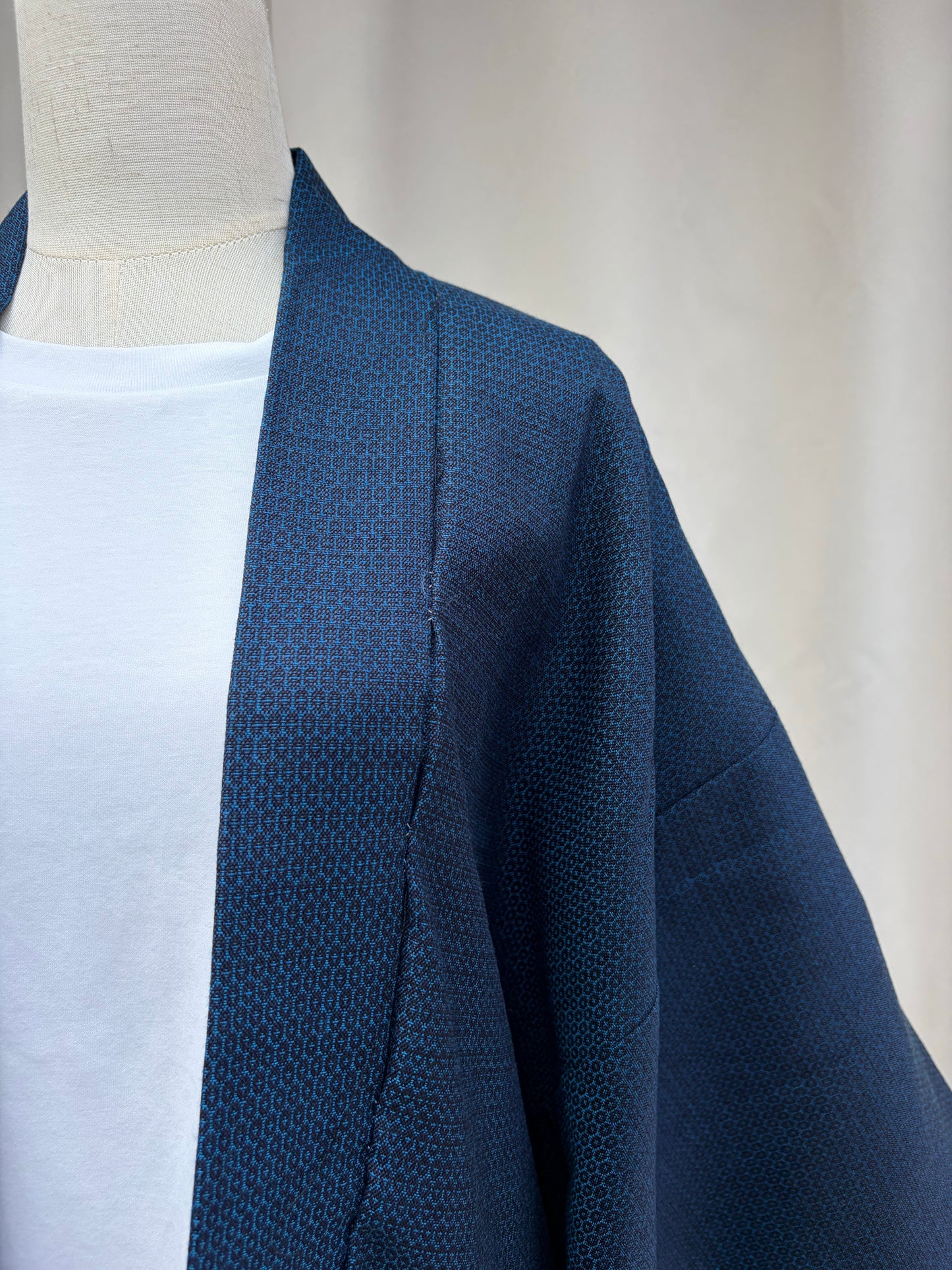 Collar and lapel edge of the navy woven haori