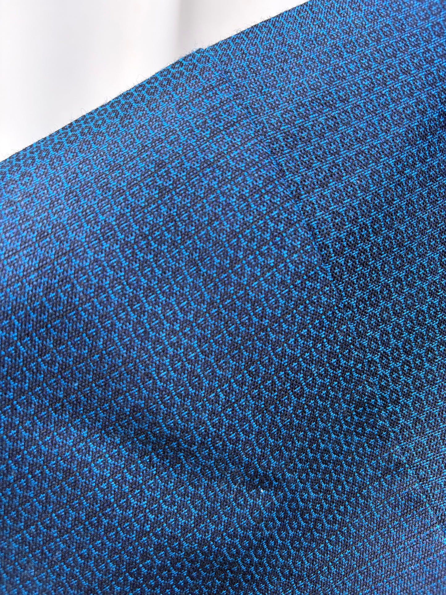 Close-up of the navy geometric woven fabric