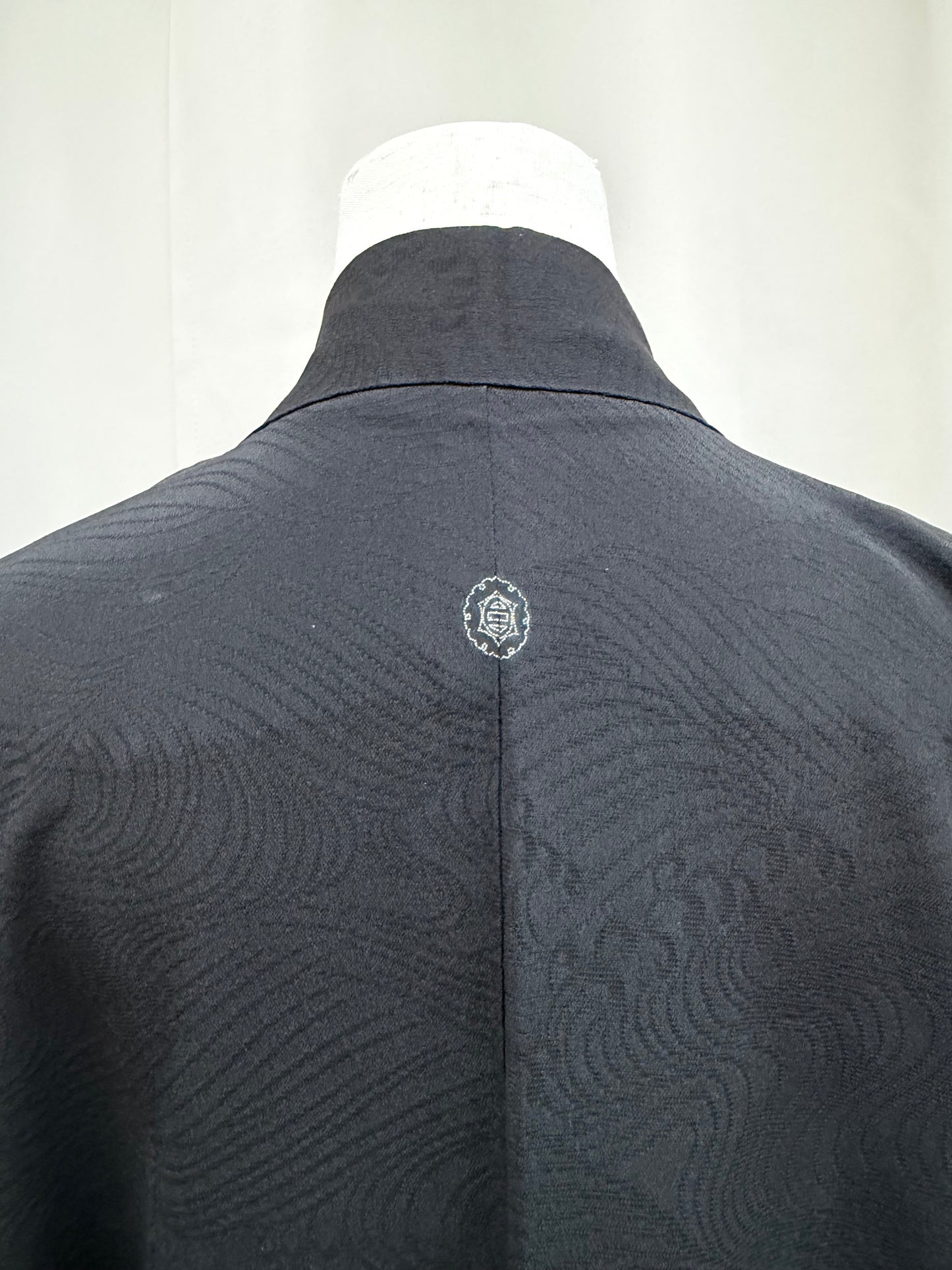 Back collar and crest detail of the black haori