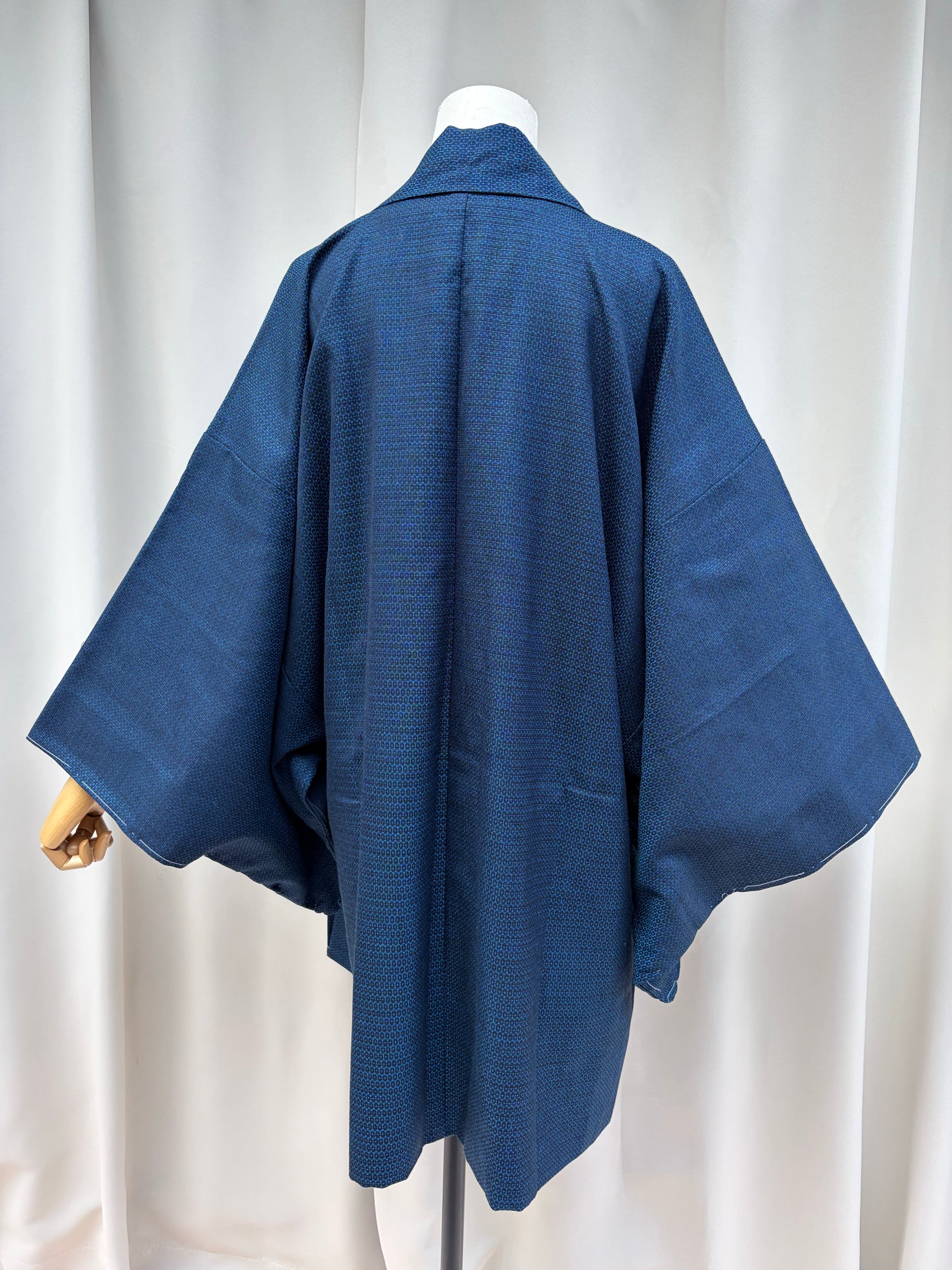 Original white basting (shitsuke) threads along the hem edge