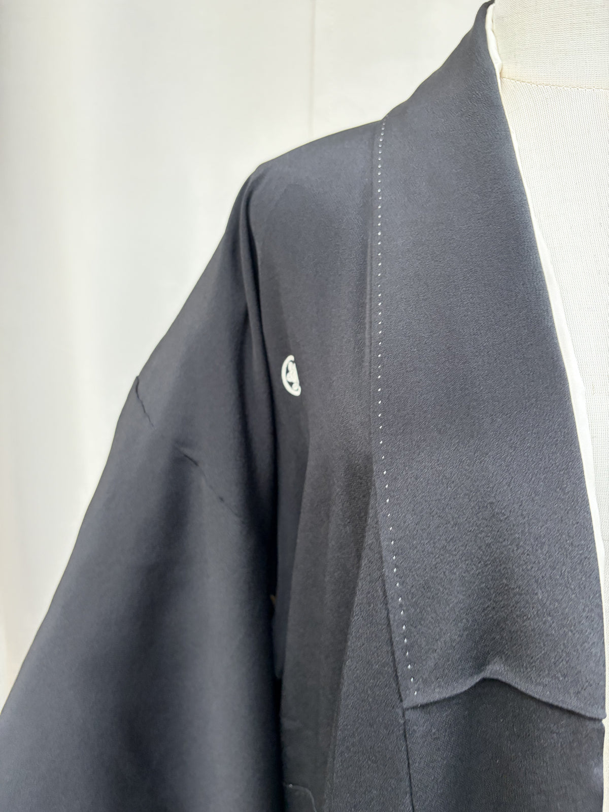 Crest at the shoulder of the black formal kimono