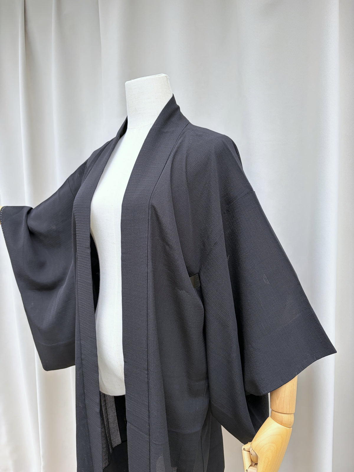 Black long haori at a three quarter angle showing the sleeve drape