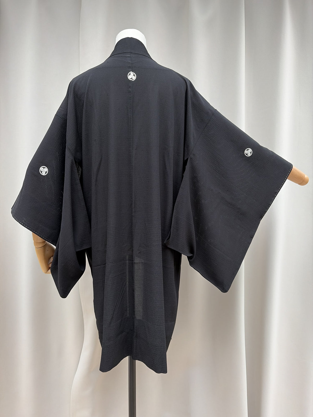 Back and sleeves of the vintage black haori with family crests