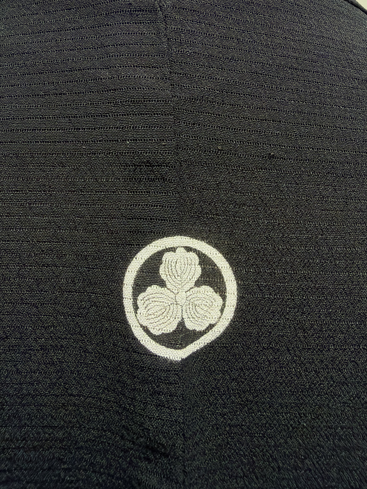 Close up of a family crest on the vintage black haori