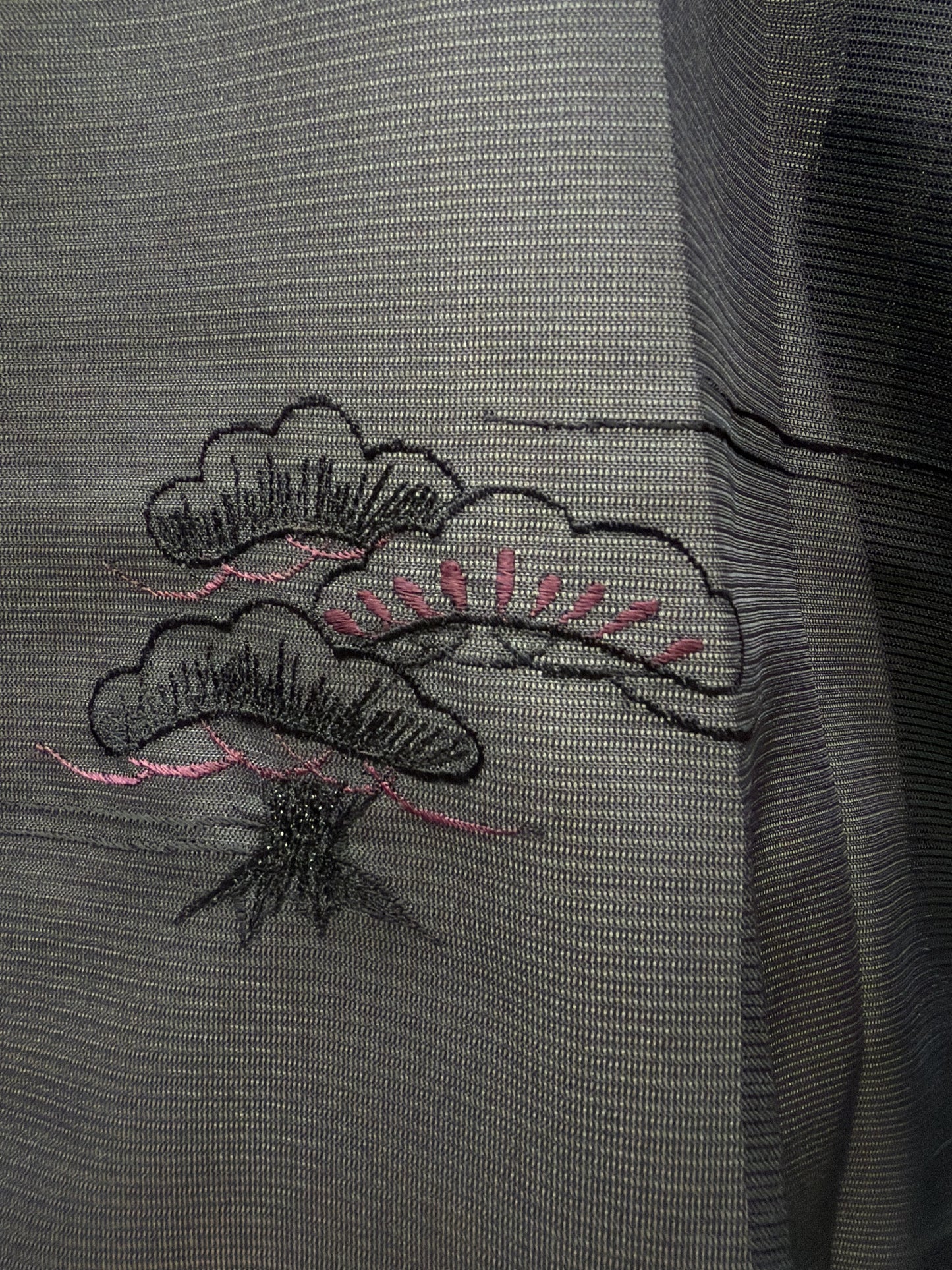 Detail of pink and black embroidery on the sheer haori