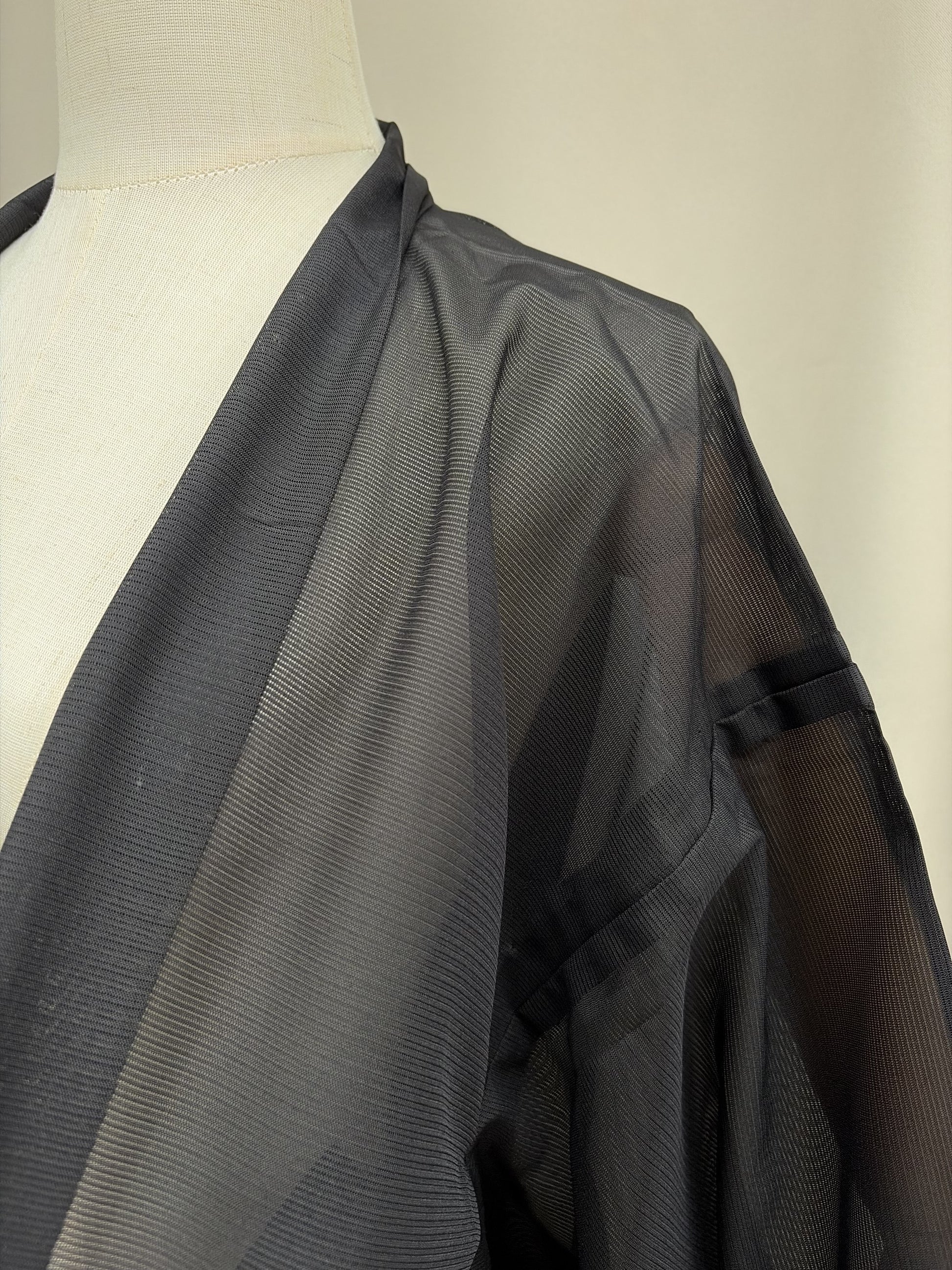 Collar and shoulder drape of the sheer black haori