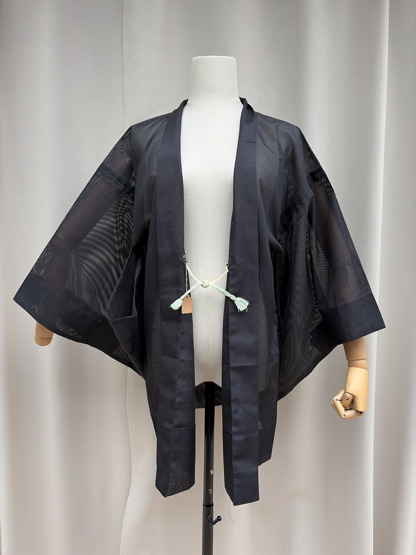 Sheer black vintage summer haori shown open on a mannequin with silk himo ties