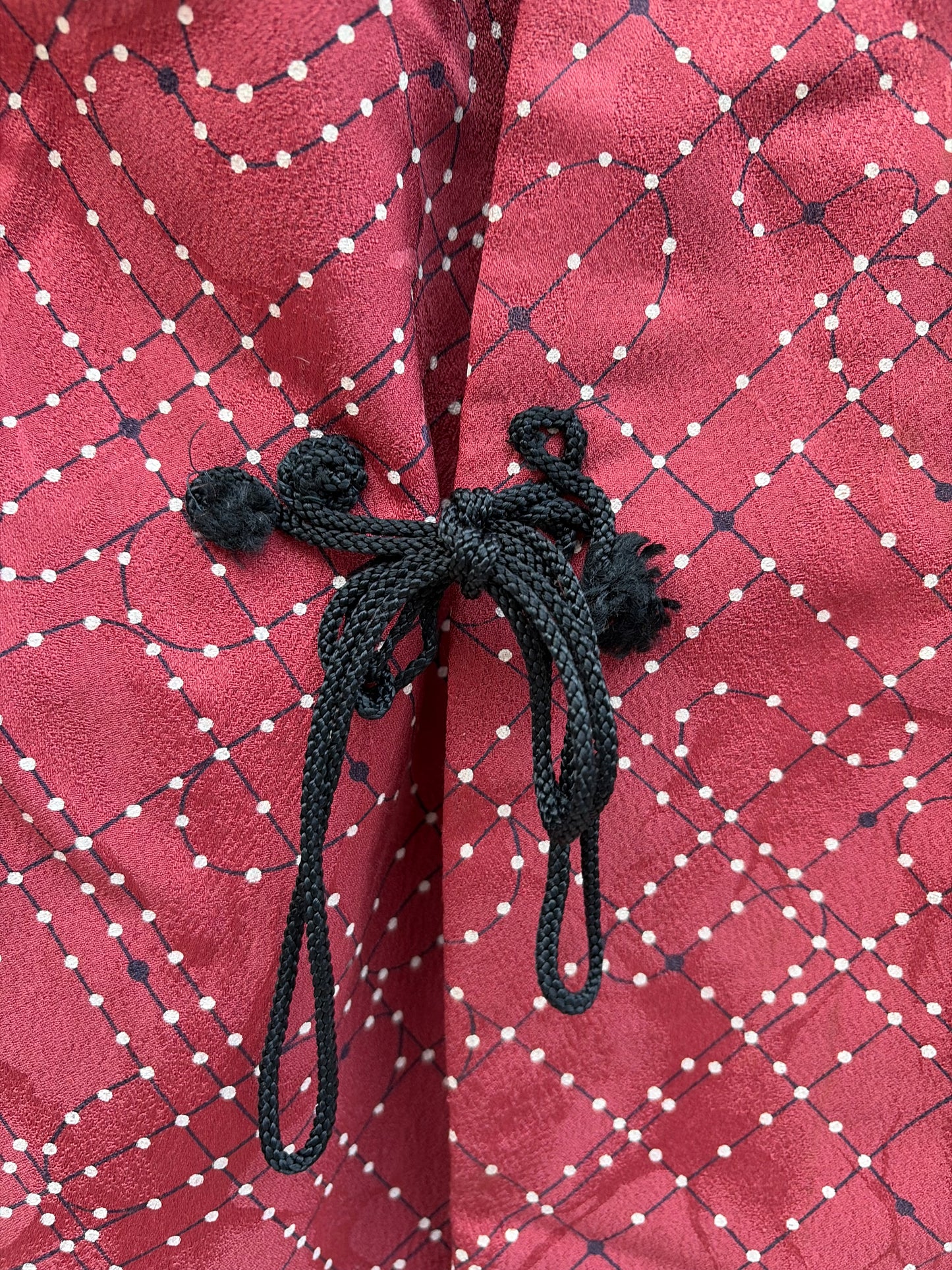 Dotted lattice pattern detail on the wine red douchugi