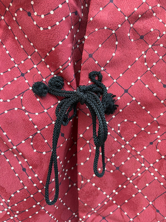 Dotted lattice pattern detail on the wine red douchugi