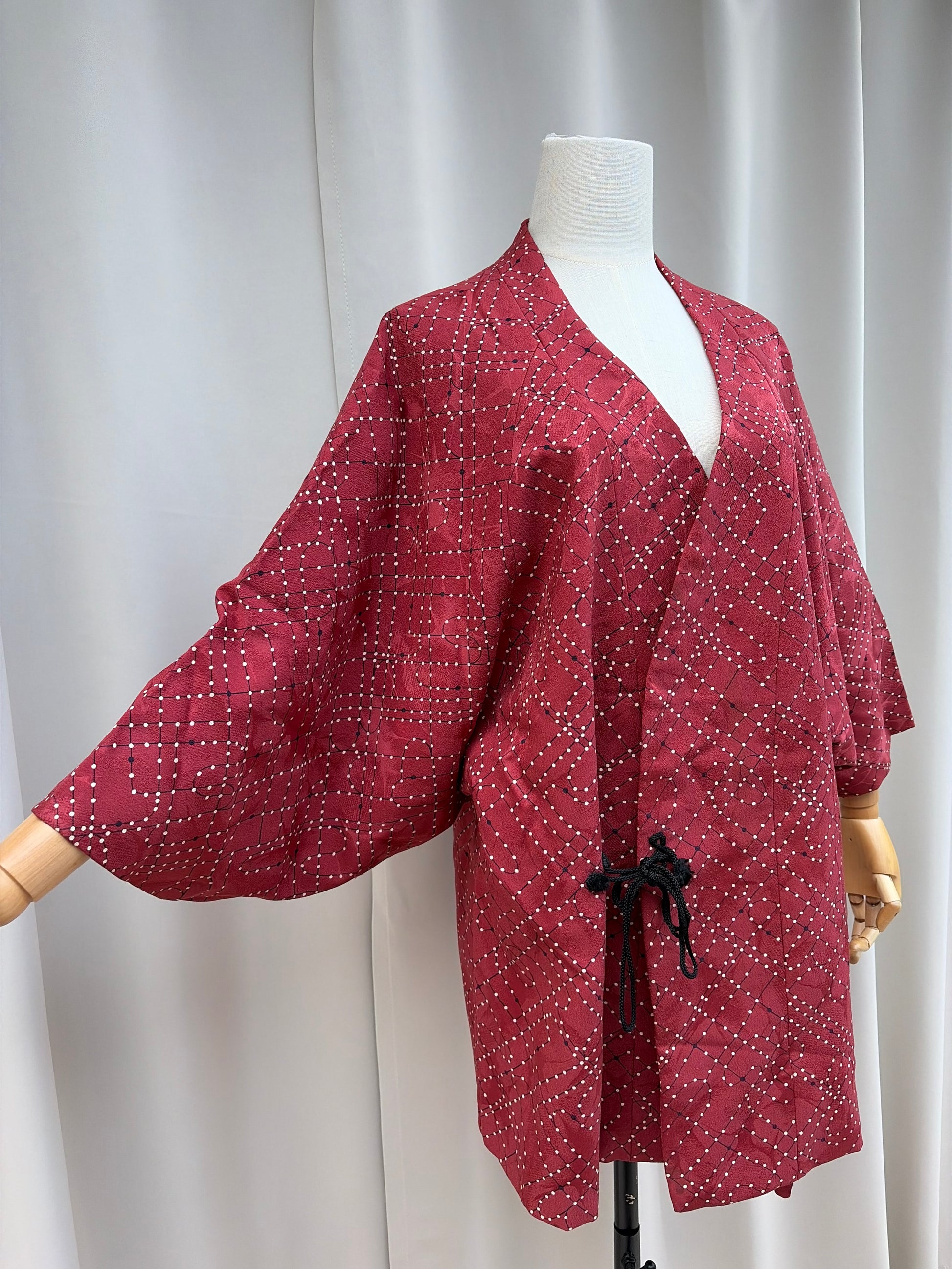 Front of the wine red douchugi showing the black cord closure