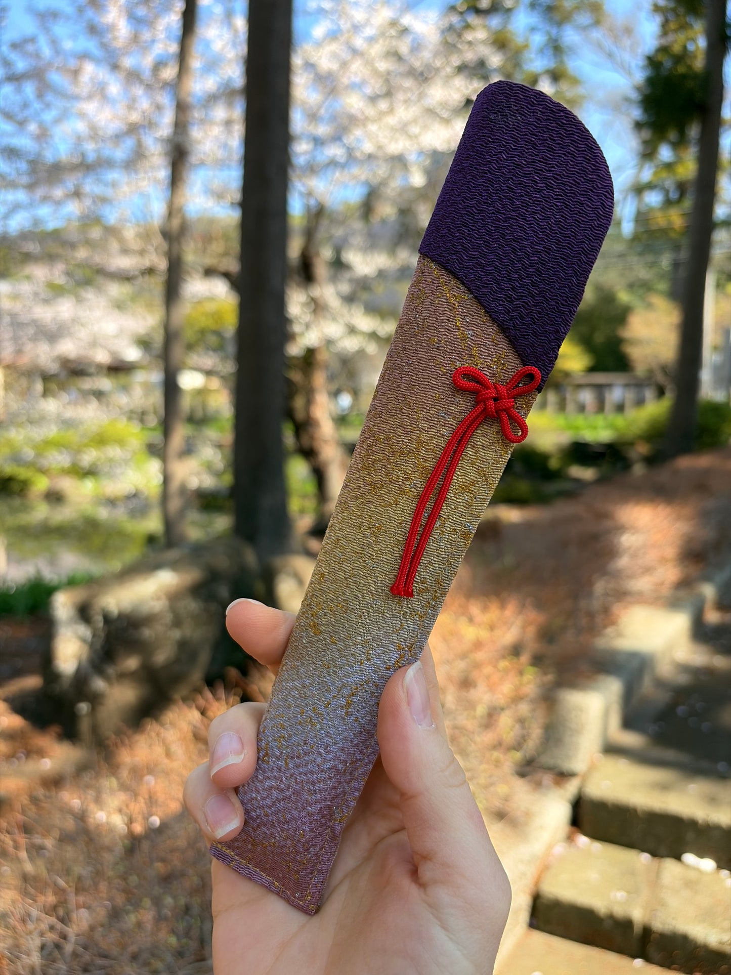 Matching deep purple fabric cover with a red cord tie for the hydrangea fan