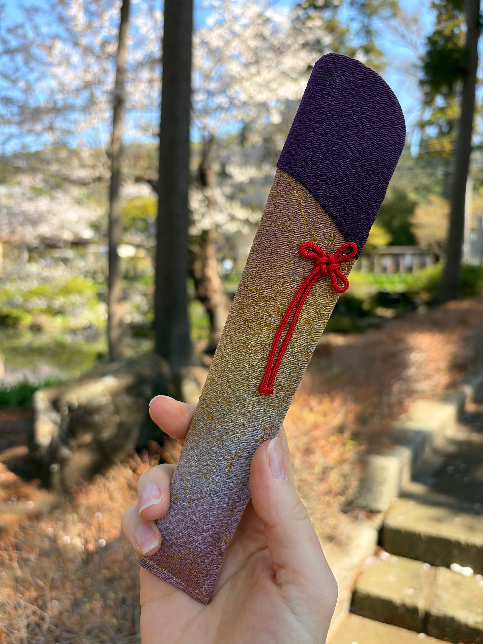 Matching deep purple fabric cover with a red cord tie for the hydrangea fan