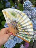 Vintage hand-painted Japanese folding fan (sensu) open, showing a mountain and village landscape