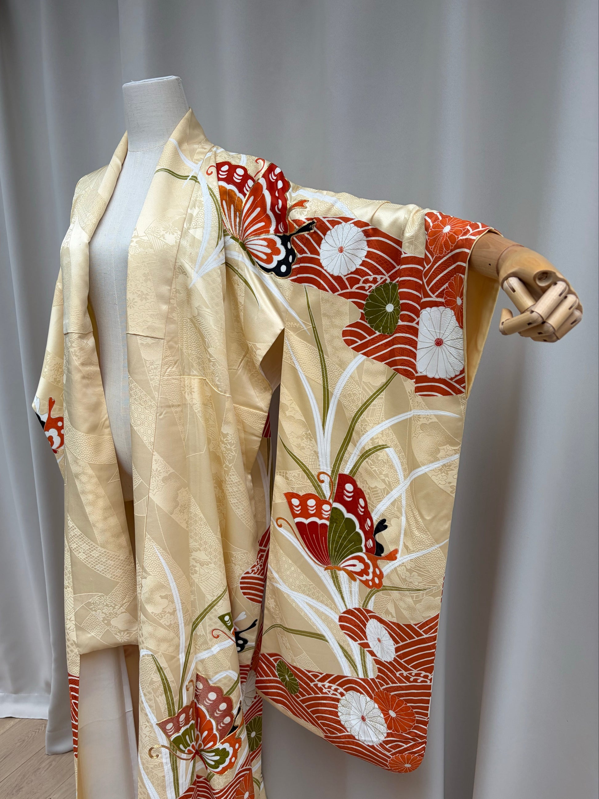 Butterfly and gold-thread embroidery detail on the furisode